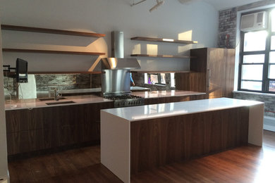Inspiration for a mid-sized modern l-shaped medium tone wood floor and brown floor open concept kitchen remodel in New York with flat-panel cabinets, medium tone wood cabinets, quartz countertops, an island, white countertops, an undermount sink, mirror backsplash and stainless steel appliances