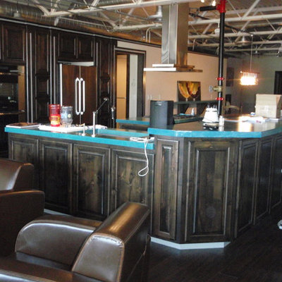 Inspiration for a large eclectic u-shaped dark wood floor eat-in kitchen remodel in Austin with raised-panel cabinets, black cabinets, concrete countertops, stainless steel appliances and two islands