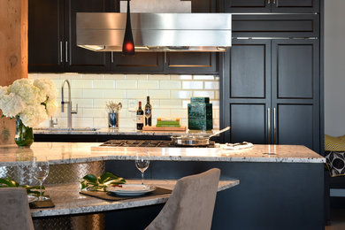 Example of a mid-sized transitional single-wall concrete floor eat-in kitchen design in Minneapolis with an undermount sink, flat-panel cabinets, dark wood cabinets, granite countertops, white backsplash, subway tile backsplash, stainless steel appliances and two islands