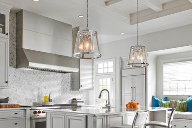 Transitional kitchen photo in Vancouver with white cabinets, gray backsplash, stainless steel appliances and an island