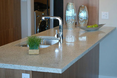 Example of a l-shaped medium tone wood floor kitchen pantry design in Other with an undermount sink, flat-panel cabinets, medium tone wood cabinets, concrete countertops and an island
