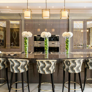 Design ideas for a large traditional single-wall kitchen in London with grey cabinets, quartz worktops, ceramic flooring, an island, beige floors, grey worktops, flat-panel cabinets, stainless steel appliances and a submerged sink.