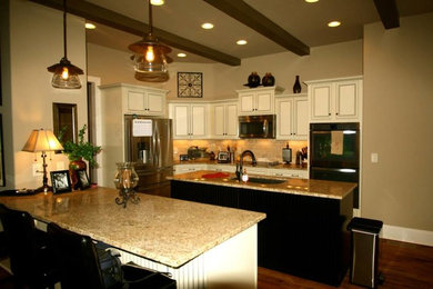 Inspiration for a mid-sized timeless single-wall dark wood floor eat-in kitchen remodel in Nashville with raised-panel cabinets, white cabinets, granite countertops, beige backsplash, ceramic backsplash, stainless steel appliances and two islands