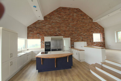 Photo of a kitchen in Cork with an integrated sink, wood worktops and brown worktops.
