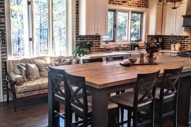 Inspiration for a large timeless l-shaped dark wood floor eat-in kitchen remodel in Charlotte with shaker cabinets, white cabinets, an island, marble countertops, red backsplash, brick backsplash, stainless steel appliances and a farmhouse sink
