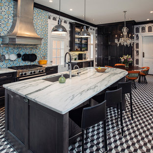 This is an example of a large eclectic l-shaped eat-in kitchen in Other with with island, an undermount sink, beaded inset cabinets, black cabinets, marble benchtops, porcelain splashback, stainless steel appliances, marble floors, multi-coloured floor, blue splashback and turquoise benchtop.