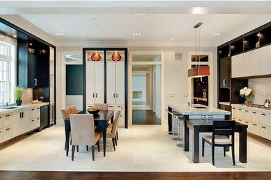 Inspiration for a huge contemporary eat-in kitchen remodel in Chicago with an undermount sink, flat-panel cabinets, white cabinets, gray backsplash, stone slab backsplash, paneled appliances and an island
