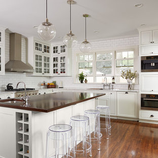 Eat-in kitchen - transitional l-shaped dark wood floor eat-in kitchen idea in Chicago with beaded inset cabinets, white cabinets, white backsplash, stainless steel appliances, an island, an undermount sink, marble countertops and subway tile backsplash