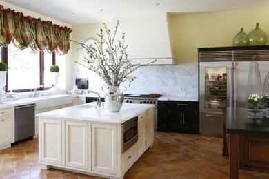 Large tuscan l-shaped terra-cotta tile kitchen photo in San Francisco with recessed-panel cabinets, white cabinets, marble countertops, two islands, an undermount sink and stainless steel appliances