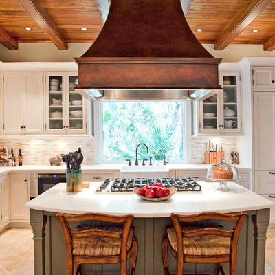 Example of a classic kitchen design in San Francisco with a farmhouse sink, recessed-panel cabinets, white cabinets, beige backsplash and matchstick tile backsplash
