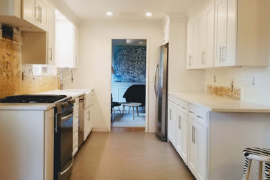 Example of a classic galley eat-in kitchen design in Seattle with no island