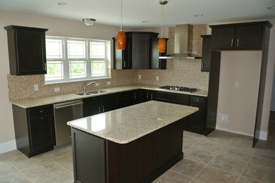 Example of a l-shaped kitchen design in Other with shaker cabinets, dark wood cabinets, granite countertops, beige backsplash and an island