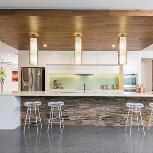 Contemporary open plan kitchen in Gold Coast - Tweed with open cabinets, white cabinets, stainless steel appliances, with island, grey floor and white benchtop.