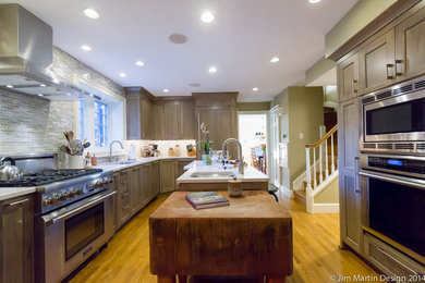 Mid-sized transitional u-shaped light wood floor eat-in kitchen photo in Philadelphia with an undermount sink, recessed-panel cabinets, gray cabinets, quartz countertops, multicolored backsplash, mosaic tile backsplash, stainless steel appliances and an island
