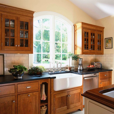 Ornate kitchen photo in New York with subway tile backsplash, a farmhouse sink and soapstone countertops