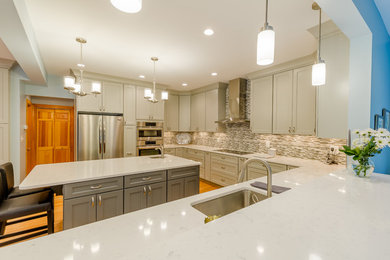 Inspiration for a large transitional u-shaped medium tone wood floor and brown floor eat-in kitchen remodel in DC Metro with an undermount sink, shaker cabinets, gray cabinets, quartzite countertops, gray backsplash, glass tile backsplash, stainless steel appliances and an island