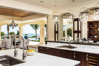 Large transitional u-shaped open concept kitchen photo in Miami with a double-bowl sink, flat-panel cabinets, dark wood cabinets, quartz countertops, gray backsplash, matchstick tile backsplash, stainless steel appliances and two islands