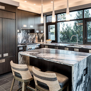 Contemporary kitchen appliance - Example of a trendy l-shaped gray floor kitchen design in Grand Rapids with an undermount sink, flat-panel cabinets, brown cabinets, multicolored backsplash, stone slab backsplash, paneled appliances, an island and multicolored countertops