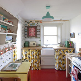 Design ideas for a small scandinavian eat-in kitchen in London with a farmhouse sink, wood benchtops, white splashback, subway tile splashback, white appliances and no island.
