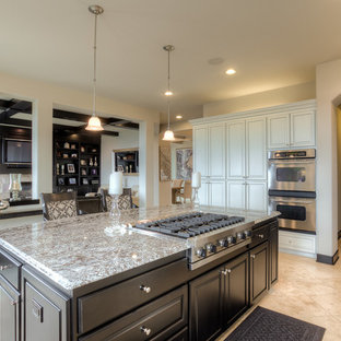 Inspiration for a mid-sized traditional galley eat-in kitchen in Seattle with an undermount sink, granite benchtops, stainless steel appliances, marble floors, with island, louvered cabinets, light wood cabinets and black splashback.