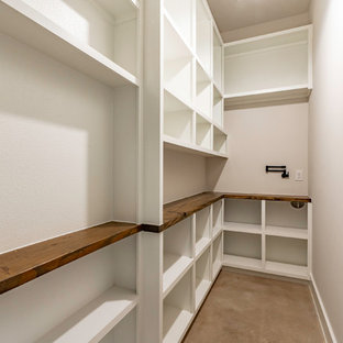 Small country l-shaped separate kitchen in Austin with open cabinets, white cabinets, wood benchtops, concrete floors, beige floor and brown benchtop.