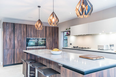 Medium sized open plan kitchen in London with an island.