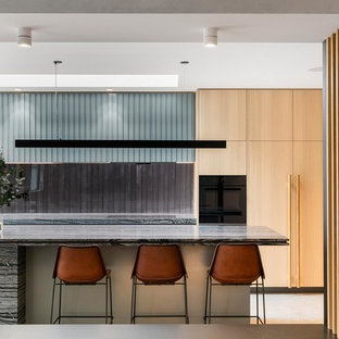 Inspiration for a contemporary galley kitchen in Melbourne with an undermount sink, flat-panel cabinets, light wood cabinets, window splashback, with island and grey benchtop.