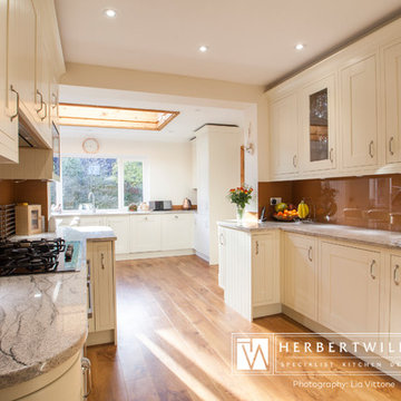 Ivory Mackintosh kitchen with stunning copper glass splashback