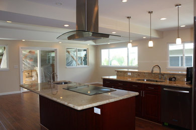 Medium sized contemporary l-shaped enclosed kitchen in Hawaii with a submerged sink, flat-panel cabinets, dark wood cabinets, granite worktops, stainless steel appliances, dark hardwood flooring, an island and brown floors.