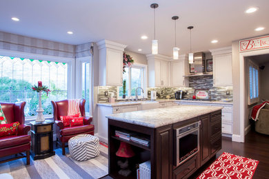 Medium sized traditional l-shaped kitchen in San Francisco with a belfast sink, recessed-panel cabinets, white cabinets, granite worktops, multi-coloured splashback, matchstick tiled splashback, stainless steel appliances, dark hardwood flooring, an island and brown floors.