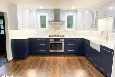 Eat-in kitchen - large transitional l-shaped dark wood floor and brown floor eat-in kitchen idea in Other with a farmhouse sink, shaker cabinets, blue cabinets, quartz countertops, multicolored backsplash, porcelain backsplash, stainless steel appliances, no island and white countertops
