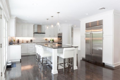 Inspiration for a contemporary kitchen remodel in Miami with shaker cabinets, white cabinets and an island