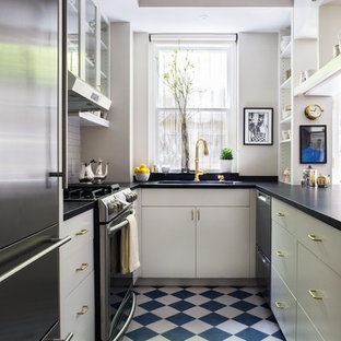 Inspiration for a small traditional galley separate kitchen in New York with white cabinets, soapstone benchtops, white splashback, porcelain splashback, stainless steel appliances, porcelain floors, no island, blue floor, an integrated sink and flat-panel cabinets.