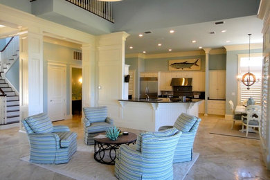 マイアミにあるお手頃価格の広いビーチスタイルのおしゃれなキッチン (レイズドパネル扉のキャビネット、白いキャビネット、シルバーの調理設備、セラミックタイルの床、茶色い床) の写真