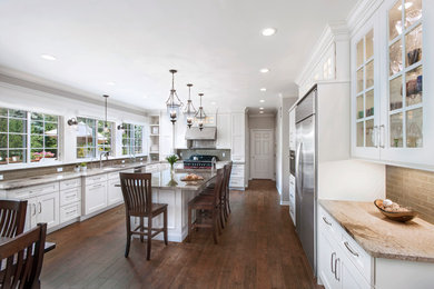 Example of a transitional eat-in kitchen design in New York with shaker cabinets and an island