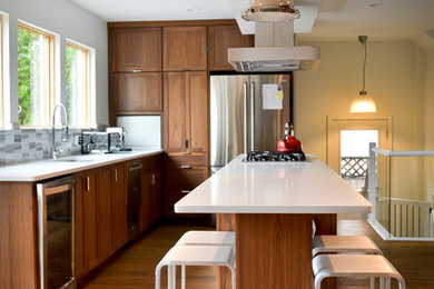 Minimalist kitchen photo in Calgary with shaker cabinets, medium tone wood cabinets and stainless steel appliances