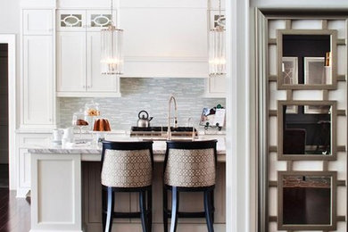 Example of a mid-sized trendy galley dark wood floor eat-in kitchen design in Toronto with an undermount sink, shaker cabinets, white cabinets, marble countertops, gray backsplash, stone tile backsplash, stainless steel appliances and an island