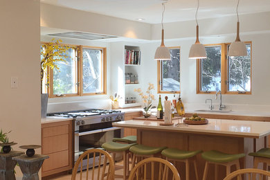 Eat-in kitchen - transitional l-shaped light wood floor eat-in kitchen idea in Boston with a single-bowl sink, flat-panel cabinets, medium tone wood cabinets, quartz countertops, white backsplash, stone slab backsplash and stainless steel appliances