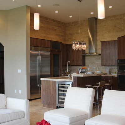 Example of a trendy l-shaped open concept kitchen design in Cedar Rapids with stainless steel appliances, flat-panel cabinets, dark wood cabinets, beige backsplash and stone tile backsplash