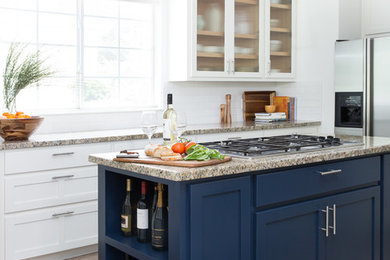 Transitional kitchen photo in Austin with glass-front cabinets, granite countertops, white backsplash, ceramic backsplash and an island