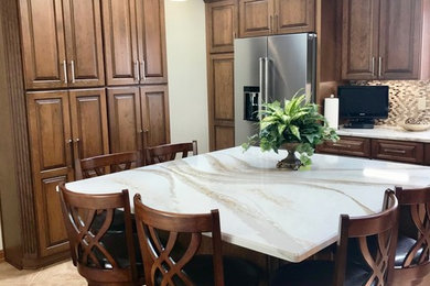 Mid-sized elegant eat-in kitchen photo in Other with an undermount sink, raised-panel cabinets, medium tone wood cabinets, quartz countertops, mosaic tile backsplash and an island
