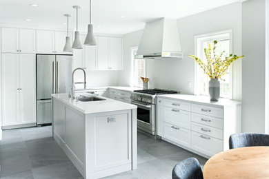 Eat-in kitchen - mid-sized transitional l-shaped porcelain tile and gray floor eat-in kitchen idea in Toronto with a single-bowl sink, shaker cabinets, white cabinets, quartz countertops, white backsplash, ceramic backsplash, stainless steel appliances, an island and white countertops