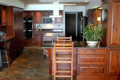 クリーブランドにあるトラディショナルスタイルのおしゃれなペニンシュラキッチン (シルバーの調理設備) の写真