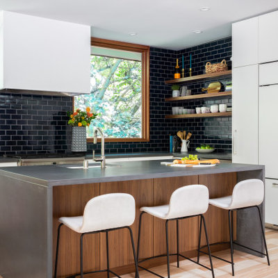 Kitchen - mid-century modern light wood floor, brown floor and vaulted ceiling kitchen idea in San Francisco with an undermount sink, flat-panel cabinets, white cabinets, concrete countertops, blue backsplash, ceramic backsplash, paneled appliances and gray countertops