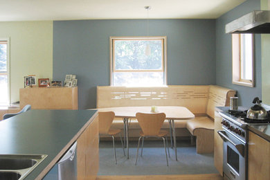 Eat-in kitchen - light wood floor eat-in kitchen idea in Detroit with a double-bowl sink, flat-panel cabinets, light wood cabinets, stainless steel appliances and an island