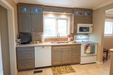 Mid-sized transitional u-shaped vinyl floor and beige floor eat-in kitchen photo in Toronto with shaker cabinets, distressed cabinets, a peninsula, a double-bowl sink, quartzite countertops, multicolored backsplash, mosaic tile backsplash and white appliances