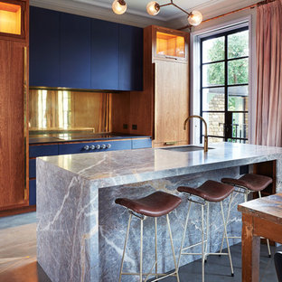 Contemporary kitchen/diner in London with a submerged sink, flat-panel cabinets, medium wood cabinets, metallic splashback, mirror splashback, integrated appliances, concrete flooring, an island, grey floors and grey worktops.