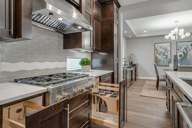 Trendy eat-in kitchen photo in Portland with shaker cabinets, stainless steel appliances and two islands
