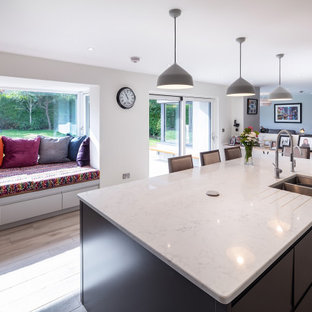Inspiration for a mid-sized modern l-shaped open plan kitchen in Other with an integrated sink, flat-panel cabinets, grey cabinets, marble benchtops, white splashback, marble splashback, stainless steel appliances, porcelain floors, with island, grey floor and white benchtop.