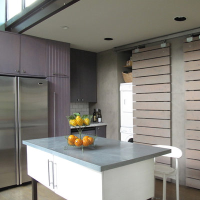 Example of a large trendy l-shaped light wood floor eat-in kitchen design in San Francisco with stainless steel appliances, an undermount sink, flat-panel cabinets, white backsplash, subway tile backsplash, an island, purple cabinets and marble countertops